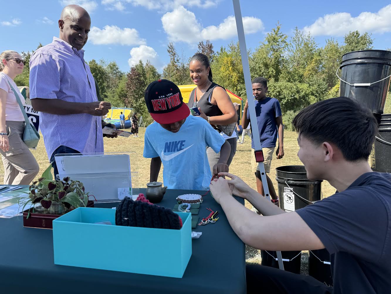 Torus volunteers with compost buckets at a community event